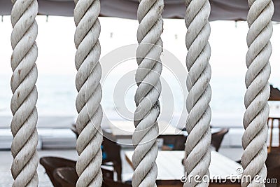 Closeup of strong string white ropes on background sea and deck. Abstract sailor marine backdrop. Textured twisted Stock Photo