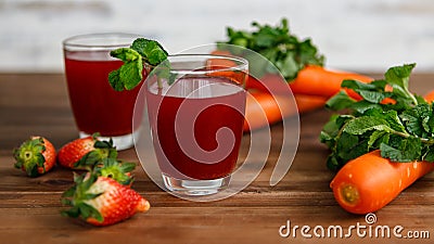 Closeup studio shot two glasses of freshly blended squeezed decorated with strawberry and carrot healthy diet vegan drink fresh Stock Photo