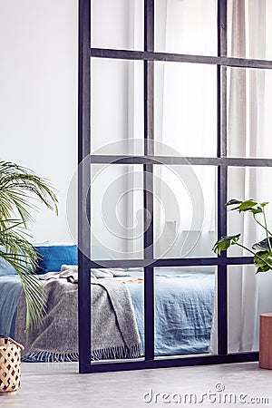 Closeup of stylish bright bedroom interior with wall divider Stock Photo