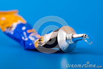 Super glue tube on blue background Stock Photo