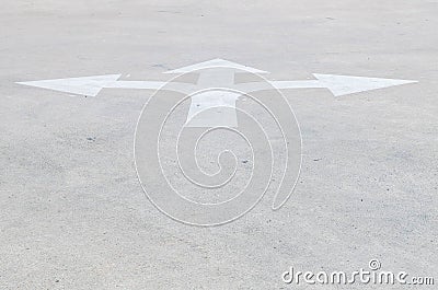 Closeup surface old and pale white painted arrow sign on cement street floor textured background with copy space Stock Photo