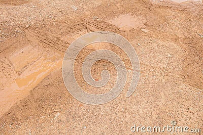 Closeup surface soil ground after rain with tire marks textured background Stock Photo