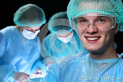Closeup of surgeons performing operation. Focus on male doctor. Medicine, surgery and emergency help concepts Stock Photo