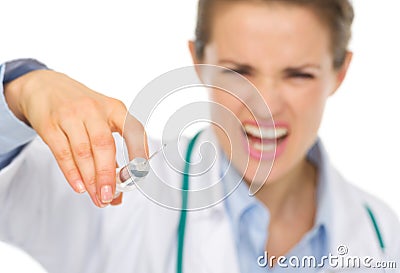 Closeup on syringe in hands of frightening doctor Stock Photo