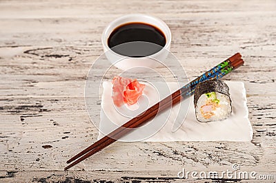 Closeup table setting by February 14th. Romantic dinner for two in chinese style and copy space. Rolls are held with chopsticks Stock Photo