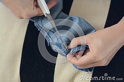 Closeup tailor hands when cutting on fabric Stock Photo