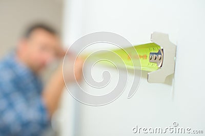 Closeup tape measure being held by tradesman Stock Photo