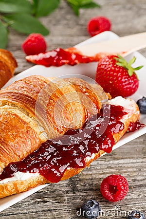 Closeup of tasty fresh appetizing croissants with fruit jam, cot Stock Photo