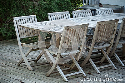 Teak garden furniture on a wooden terrace in spring Stock Photo