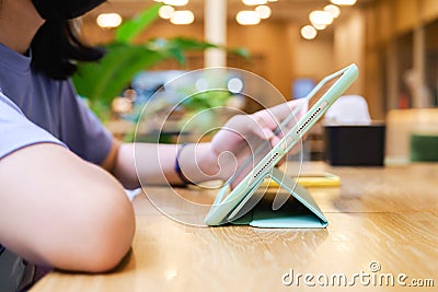 Girl using digital tablet in the cafe Stock Photo