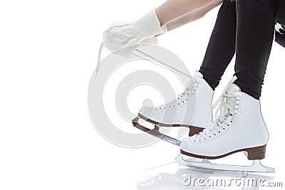 Closeup of Teenager Girl Hands Lacing Up Ice Skates Against White Stock Photo