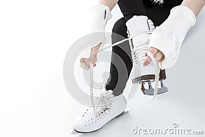 Closeup of Teenager Girl hands Lacing Up Iceskates Stock Photo