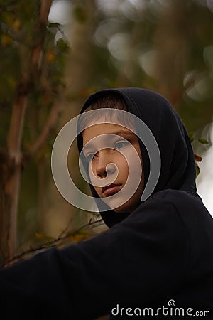 Closeup of a teenager wearing a hoodie, underlit Stock Photo