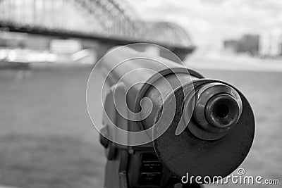 Closeup of a telescope isolated on the shore of the river Stock Photo