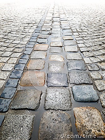 Closeup texture of wet stone pavement and rain puddles Stock Photo