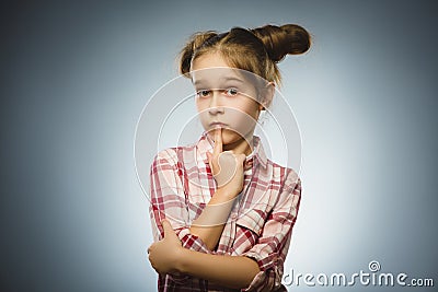 Closeup Thoughtful girl with Hand at head isolated on Gray Stock Photo