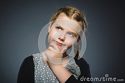Closeup Thoughtful girl with Hand at head isolated on Gray Stock Photo