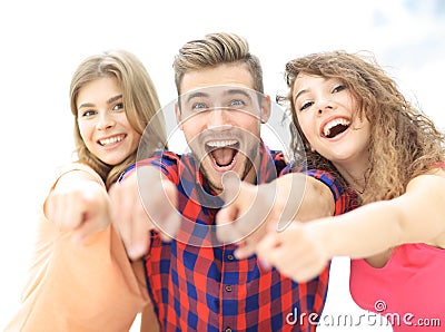 Closeup of three happy young people showing hands forward Stock Photo