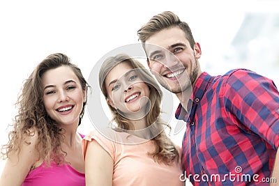 Closeup of three young people smiling on white background Stock Photo