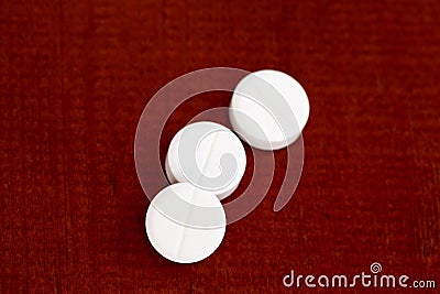 Closeup of three white pills Stock Photo