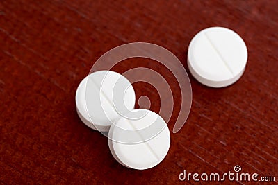 Closeup of three white pills Stock Photo