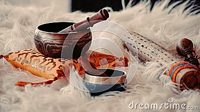 Closeup of Tibetan singing bowls and other Shamanic tools for energy healing on a fluffy surface Stock Photo