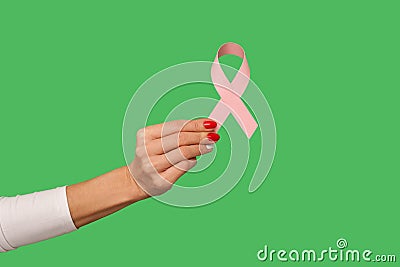 Closeup of tiny female hand with manicure holding pink ribbon, symbol of breast cancer awareness Stock Photo
