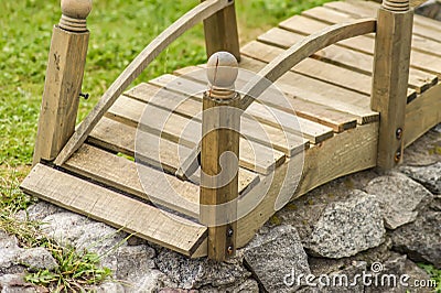 Closeup of tiny wooden bridge. Garden decoration Stock Photo