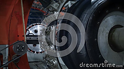 Closeup tire factory mechanism working process with uniformed worker checking Stock Photo