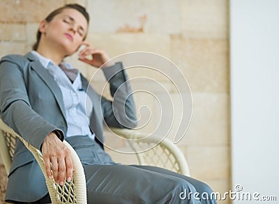 Closeup on tired business woman relaxing on chair Stock Photo