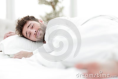 Closeup.the tired men sleep soundly on the bed Stock Photo
