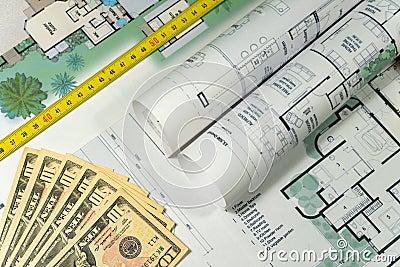 Closeup to floor plans, measuring yellow tape and US dollars. Architect drawings, expensive renovation, building construction Stock Photo