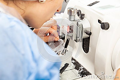Closeup to the scientist hands working on a rotary microtome to obtain sections from a paraffin-embedded specimen Stock Photo