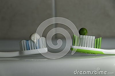 Closeup of toothpaste squeezed on the toothbrushes Stock Photo