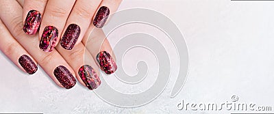 Closeup top view of two beautiful female hands with elegant classic professional fresh red manicure Stock Photo