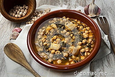 Closeup of a traditional casserole of chickpeas with spinach and cod Stock Photo