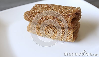 Closeup of a traditional local Malaysian dessert known as kuih sarang semut or kuih jala. Selective focus Stock Photo