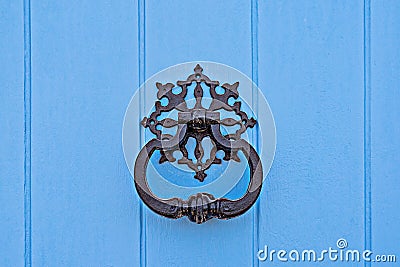 Closeup of traditional maltese door beater on blue door Stock Photo