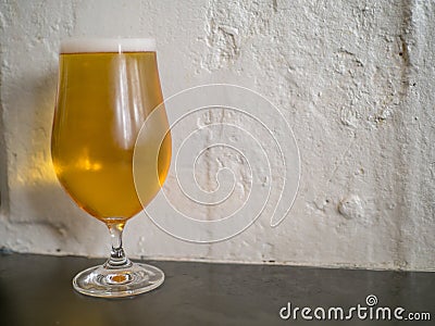 Closeup of tulip glass filled with Belgian beer Stock Photo