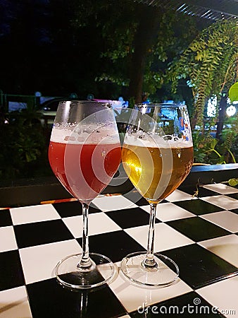 A closeup of two glasses of alcohol cocktails on a bar counter. Stock Photo