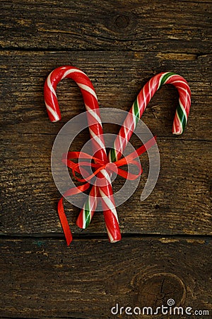 Closeup of two old fashioned candy canes on a rustic wooden back Stock Photo