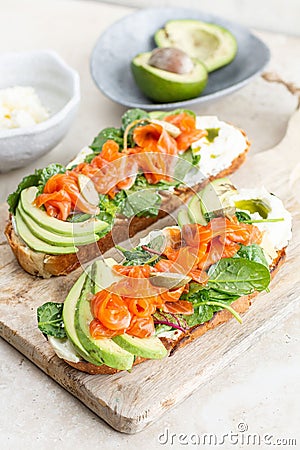 Closeup of two open-faced sandwiches on wooden platters with fresh vegetables on it Stock Photo