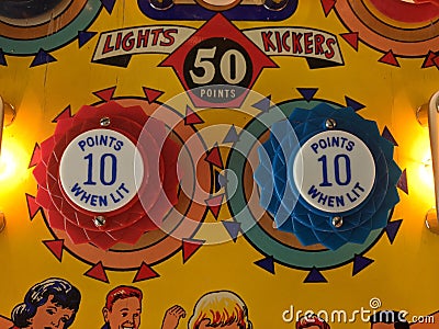 Closeup of two pop bumpers on vintage pinball Bowling Queen Editorial Stock Photo