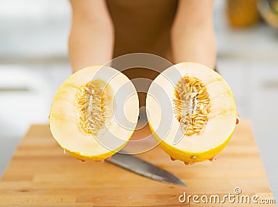Closeup on two slices of melon in hand of woman Stock Photo