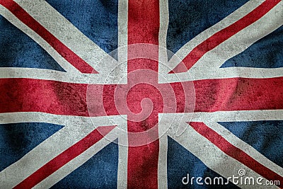 Closeup of Union Jack flag. UK Flag. British Union Jack flag blowing in the wind. Concrete background Stock Photo