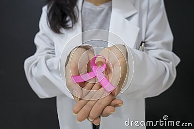 Unknown female doctor holding pink ribbon Stock Photo