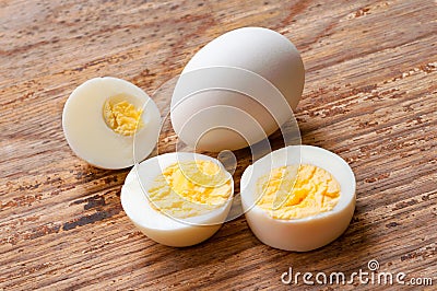 Closeup unpeeled boiled egg and half eggs on white background , Stock Photo