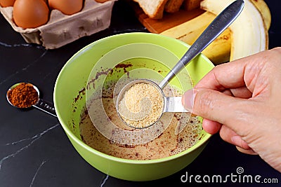 Unrefined Sugar Being Added in the Mixture for Baking Banana Bread Pudding Stock Photo