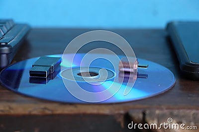 Closeup of a usb flash drives on a disc against a blue light. Stock Photo