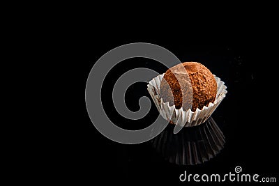 Closeup useful handmade round chocolate candy on black background Stock Photo